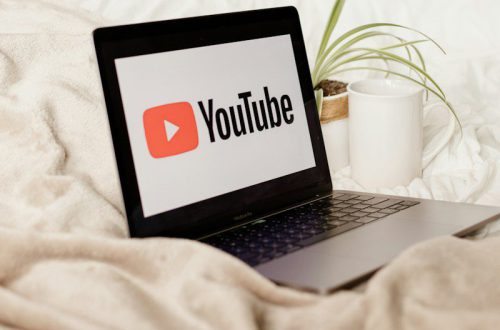 a laptop computer sitting on top of a bed